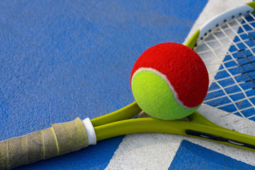 tennis ball and racket in an outdoor court