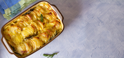 Potato gratin (with cream and butter). Scalloped potatoes or potato bake. View from above, top...
