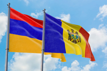 Moldova and Armenia flags waving in the wind against white cloudy blue sky together. Diplomacy concept, international relations.