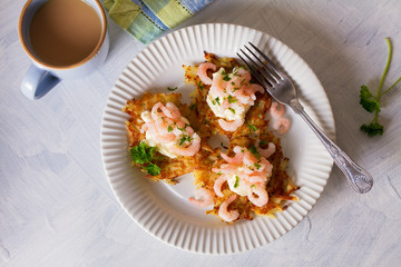 Potato cakes with topping: cream cheese and shrimps. Vegetable fritters, latkes, draniki. Vegetable pancakes. View from above, top view