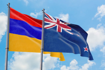 New Zealand and Armenia flags waving in the wind against white cloudy blue sky together. Diplomacy concept, international relations.