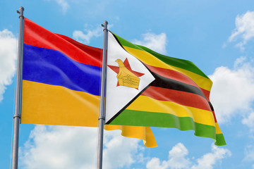 Zimbabwe and Armenia flags waving in the wind against white cloudy blue sky together. Diplomacy concept, international relations.