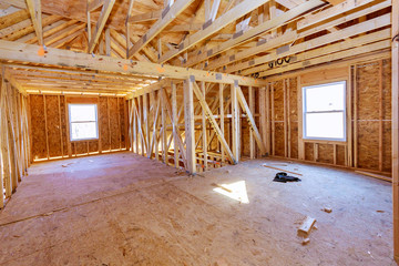 Unfinished attic of private house residential construction house framing agains