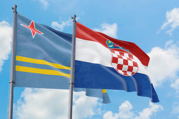 Croatia and Aruba flags waving in the wind against white cloudy blue sky together. Diplomacy...