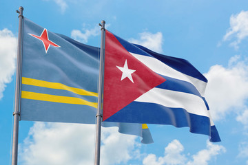 Cuba and Aruba flags waving in the wind against white cloudy blue sky together. Diplomacy concept, international relations.