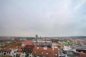 Aerial panorama of Brno, Czech Republic, with a focus on a residential suburb with skyscrapers in background, from the roofs of houses. Brno is the second biggest Czech city.
