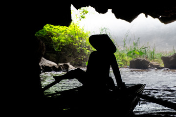 Silhouette of Person Rowing in Cave