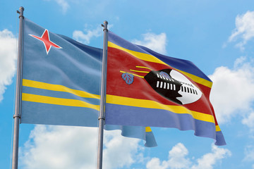 Swaziland and Aruba flags waving in the wind against white cloudy blue sky together. Diplomacy concept, international relations.