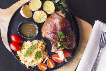 baked pork shank with vegetable side dish