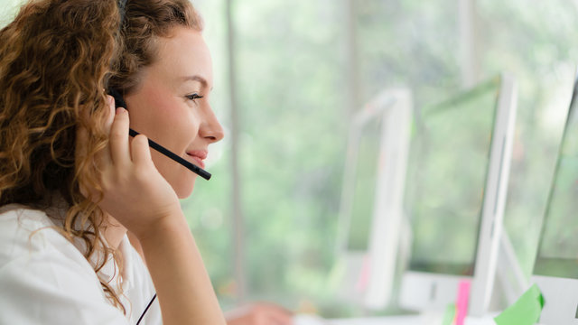 business background of caucasian female call center agent on service with call from customer at customers relation and helpdesk center