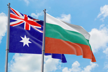 Bulgaria and Australia flags waving in the wind against white cloudy blue sky together. Diplomacy concept, international relations.