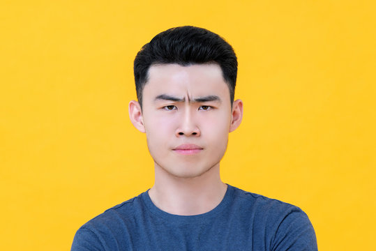 Close Up Of Unhappy Angry Young Asian Man Face