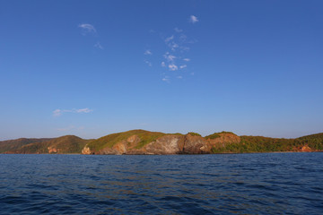 Island in the sea and bright sky.