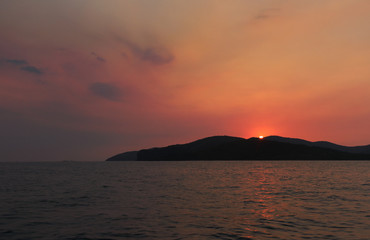 Naklejka na ściany i meble Sunset from the island in the sea.