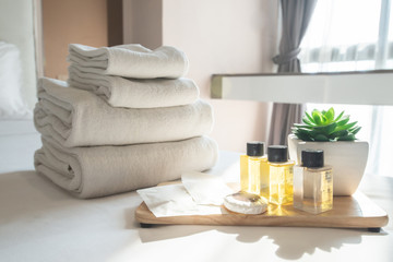 Set of hotel amenities (such as towels, shampoo, soap etc) on the bed. Hotel amenities is something...