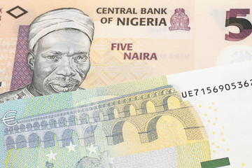 An orange five naira note from Nigeria with a five euro German bank note close up in macro