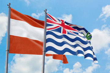 British Indian Ocean Territory and Austria flags waving in the wind against white cloudy blue sky together. Diplomacy concept, international relations.