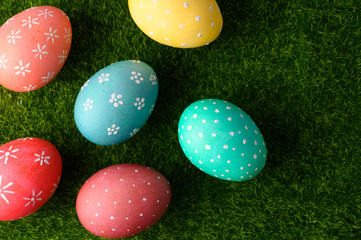 Fototapeta na wymiar Easter eggs on grass flat lay, easter composition. With space