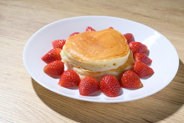 pancake and strawberry fruit sweet dessert food put on breakfast table