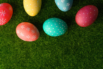 Fototapeta na wymiar Easter greetings. Easter painted eggs on green grass. Spring religious holiday Easter.
