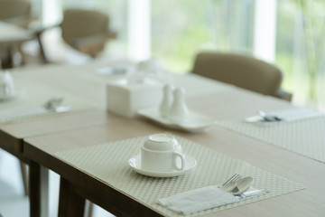 Coffee cup on wooden table for the freshness in coffee shop