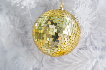 Golden Ball on White Christmas Tree