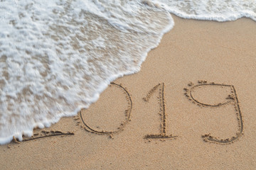 Abstract message Year 2019 written on beach sand