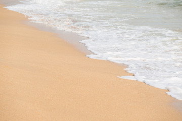 Soft foam wave and sea on the sandy beach