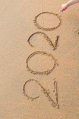Abstract message Year 2020 written on beach sand