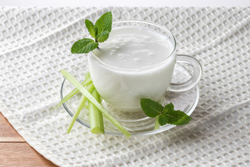 Pouring homemade kefir, yogurt with probiotics. Probiotic cold sour-milk drink. Fashionable food...