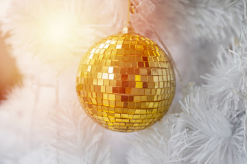 Golden Ball on White Christmas Tree