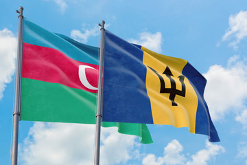 Barbados and Azerbaijan flags waving in the wind against white cloudy blue sky together. Diplomacy concept, international relations.