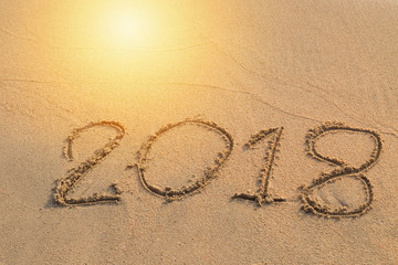 2018 message written in the sand at the beach