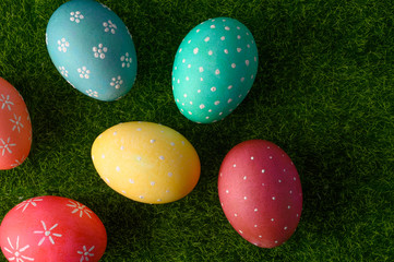 Easter colored eggs on green grass.Flat lay