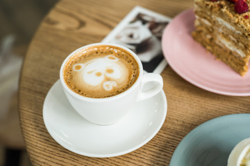 cup of Cappuccino with coffee art with bear