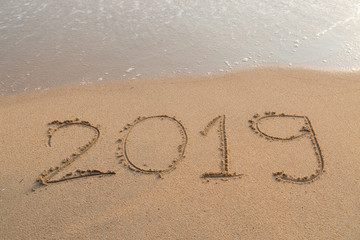 Abstract message Year 2019 written on beach sand