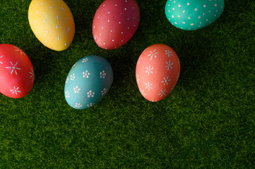 Fototapeta na wymiar easter eggs on grass flat lay, easter composition. with space on grass.