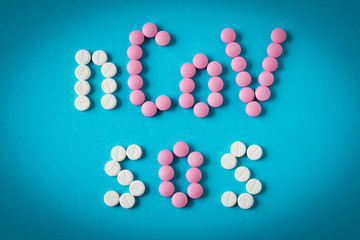 Coronavirus. Inscription from pills on a blue background. The concept of protection from viruses.