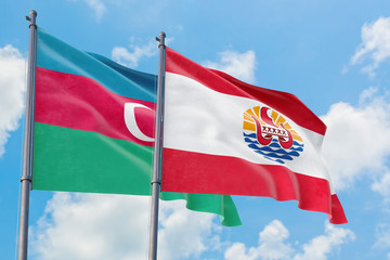 French Polynesia and Azerbaijan flags waving in the wind against white cloudy blue sky together. Diplomacy concept, international relations.