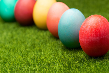 Easter painted eggs on green grass, screensaver for easter greetings