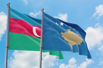 Kosovo and Azerbaijan flags waving in the wind against white cloudy blue sky together. Diplomacy concept, international relations.