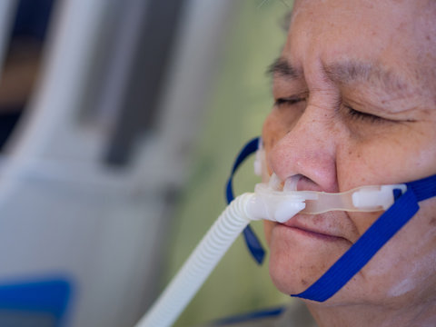 Close Up Of Elderly Woman Patients With Lung Disease, Getting Oxygen For Treatment In The Room At Hospital. Space For Text. Health Care Concept