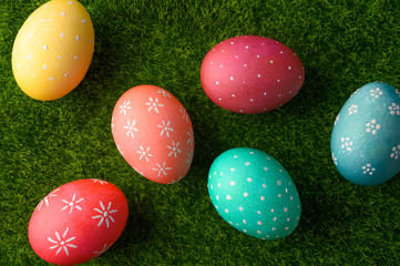 Easter colored eggs on green grass.Flat lay