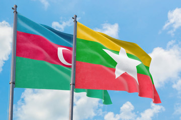 Myanmar and Azerbaijan flags waving in the wind against white cloudy blue sky together. Diplomacy concept, international relations.