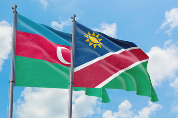 Namibia and Azerbaijan flags waving in the wind against white cloudy blue sky together. Diplomacy concept, international relations.