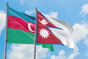 Nepal and Azerbaijan flags waving in the wind against white cloudy blue sky together. Diplomacy concept, international relations.