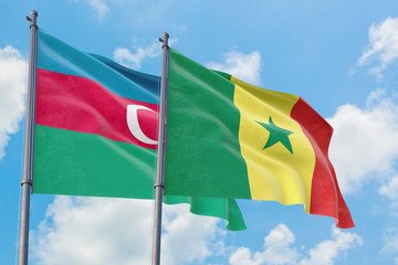 Senegal and Azerbaijan flags waving in the wind against white cloudy blue sky together. Diplomacy concept, international relations.