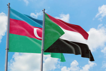 Sudan and Azerbaijan flags waving in the wind against white cloudy blue sky together. Diplomacy concept, international relations.