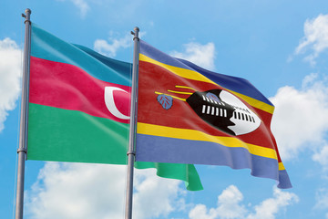 Swaziland and Azerbaijan flags waving in the wind against white cloudy blue sky together. Diplomacy concept, international relations.