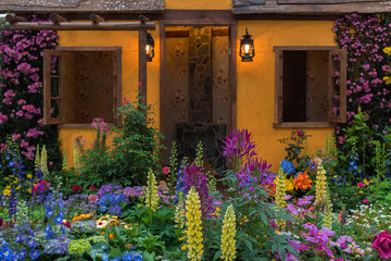 Fototapeta na wymiar Landscaped backyard of house with flower garden